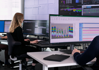 Coworkers in front of monitors