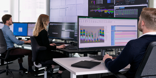Coworkers in front of monitors